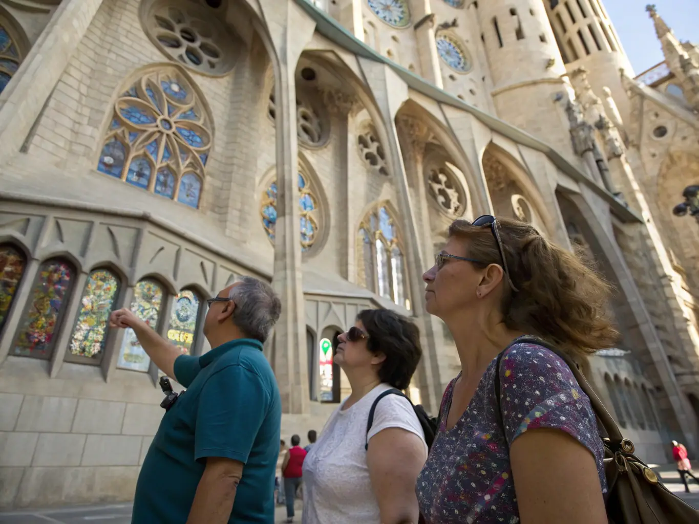 A photograph capturing a group of participants engaged in a guided tour of the Basilica de Liesse, focusing on the architectural details and historical significance of the site. The image should convey a sense of discovery and learning.